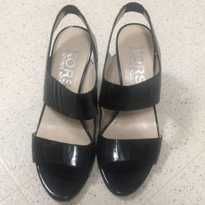 Black sling back Michael Kors heels.